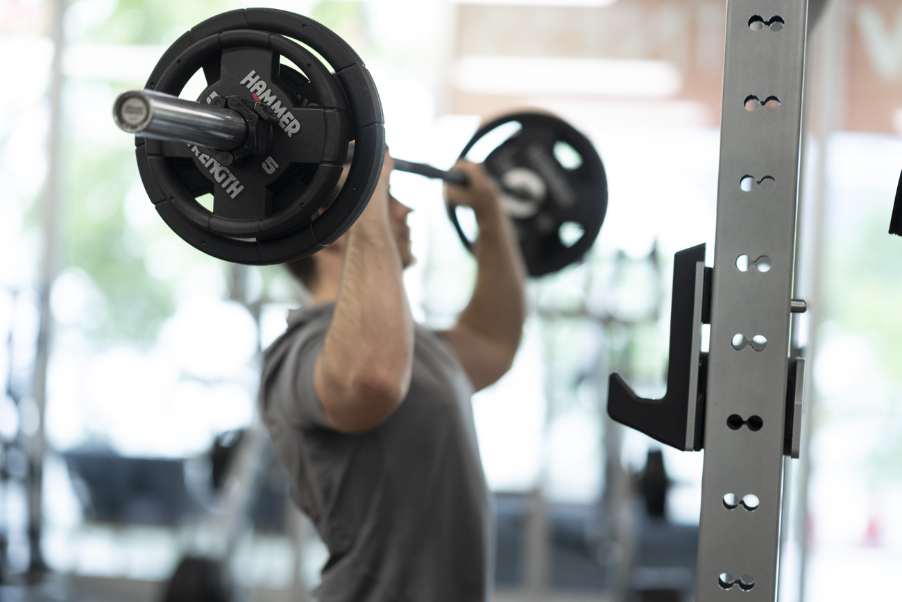 Photo of man in the gym lifting weights.
