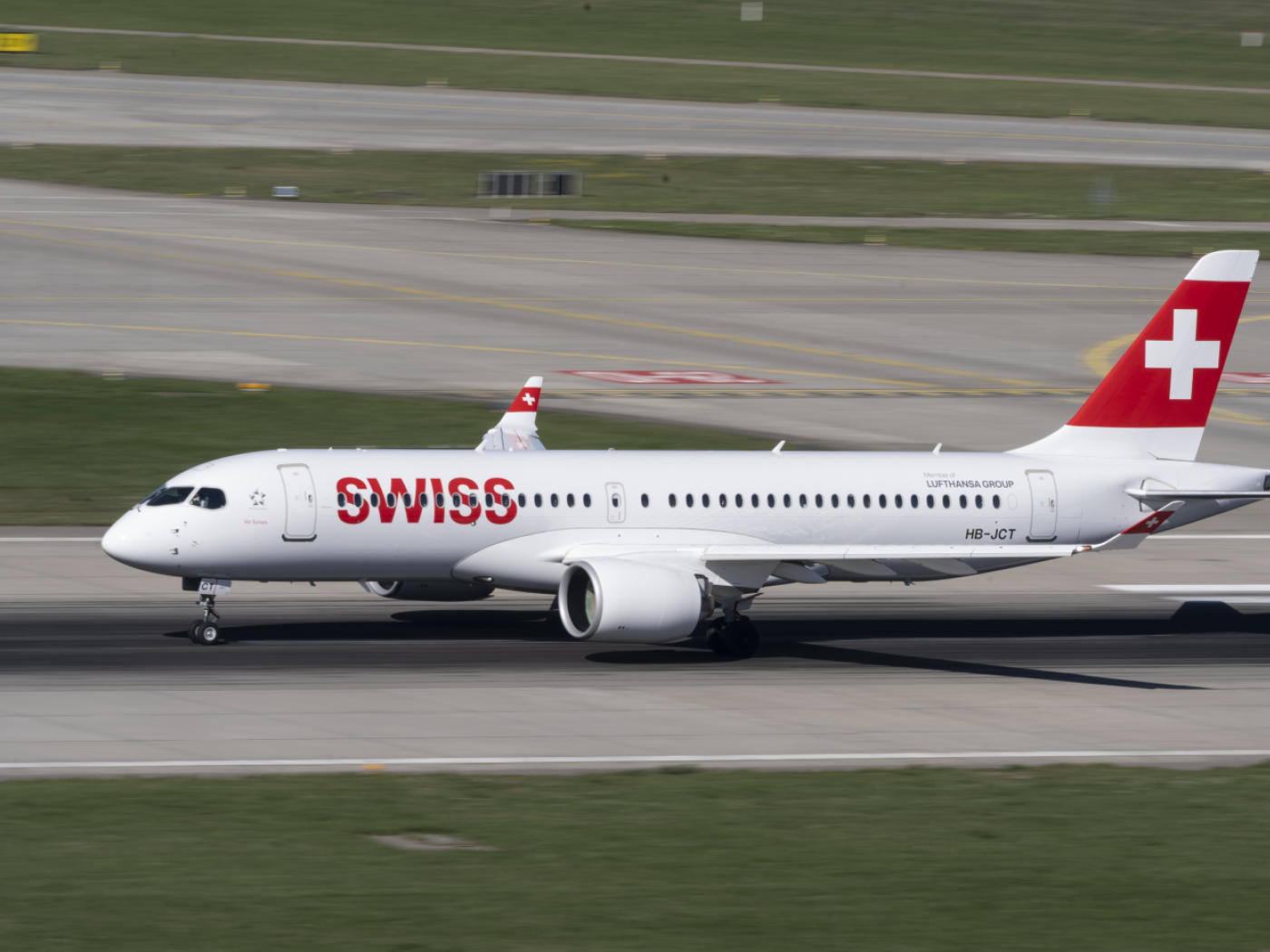 Smoke from a headphone case on a Swiss flight; unscheduled landing