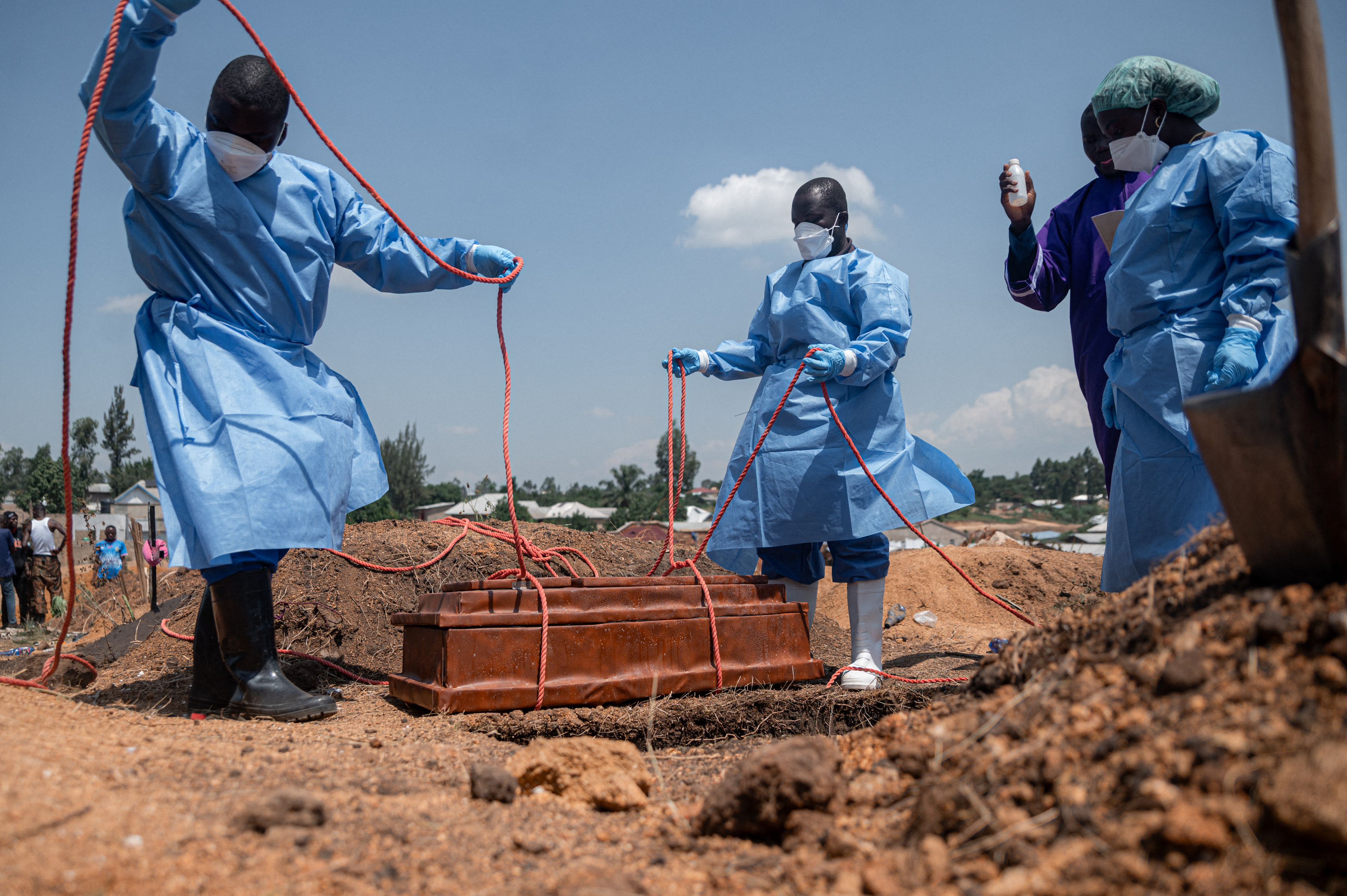 Teams from the International Federation of the Red Cross and Red Crescent Societies prepare for burial at Mbiyo cemetery the body of a fourth orphan who died from Ebola virus disease at an orphanage in Bunia, Ituri Province, June 19, 2026