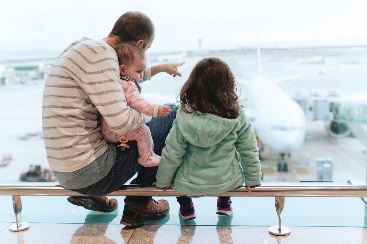 A father with two children at the airport