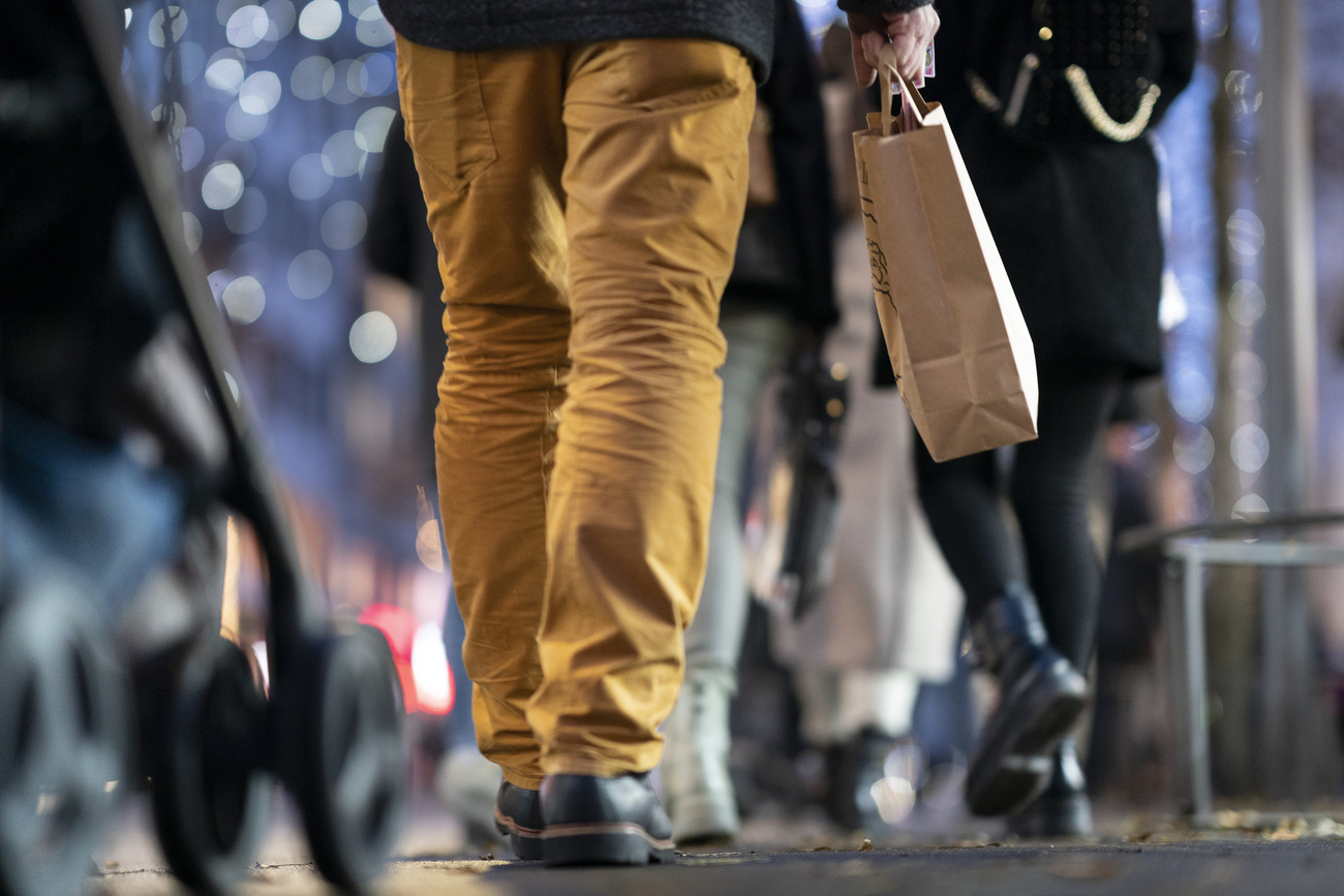 Shopper walking with a bag on high street