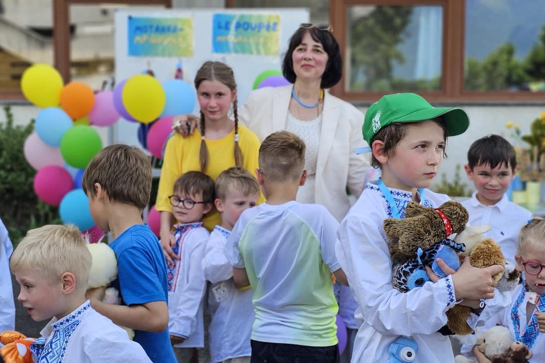 Natalia Lashchevskaya, director of the Wings of Hope children’s home, surrounded by children.