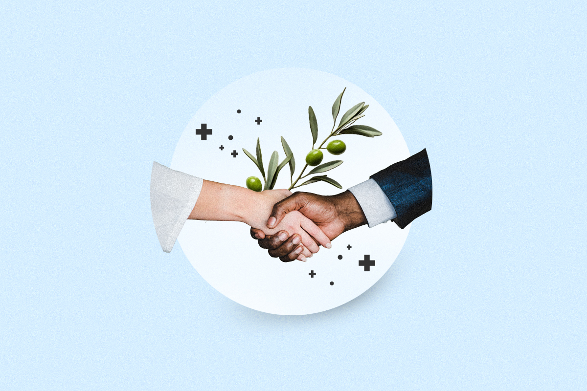 Shaking hands over the ancient peace symbol of an olive branch