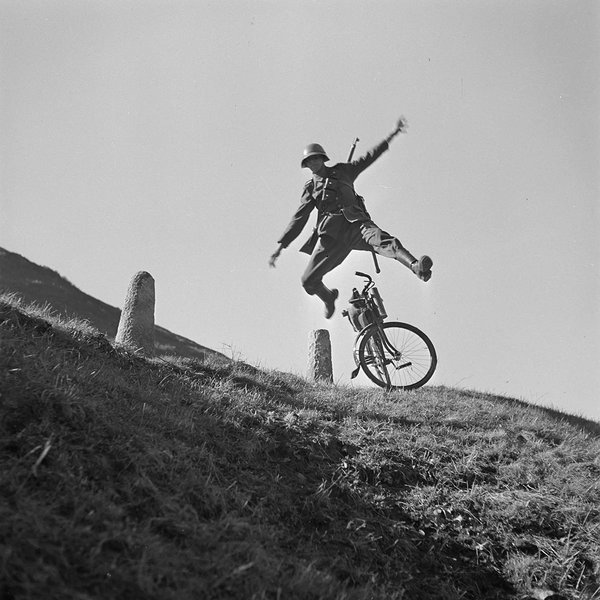Ein Velofahrer springt auf einer Passstrasse über seinen Lenker. Foto von Karl Egli, um 1935.