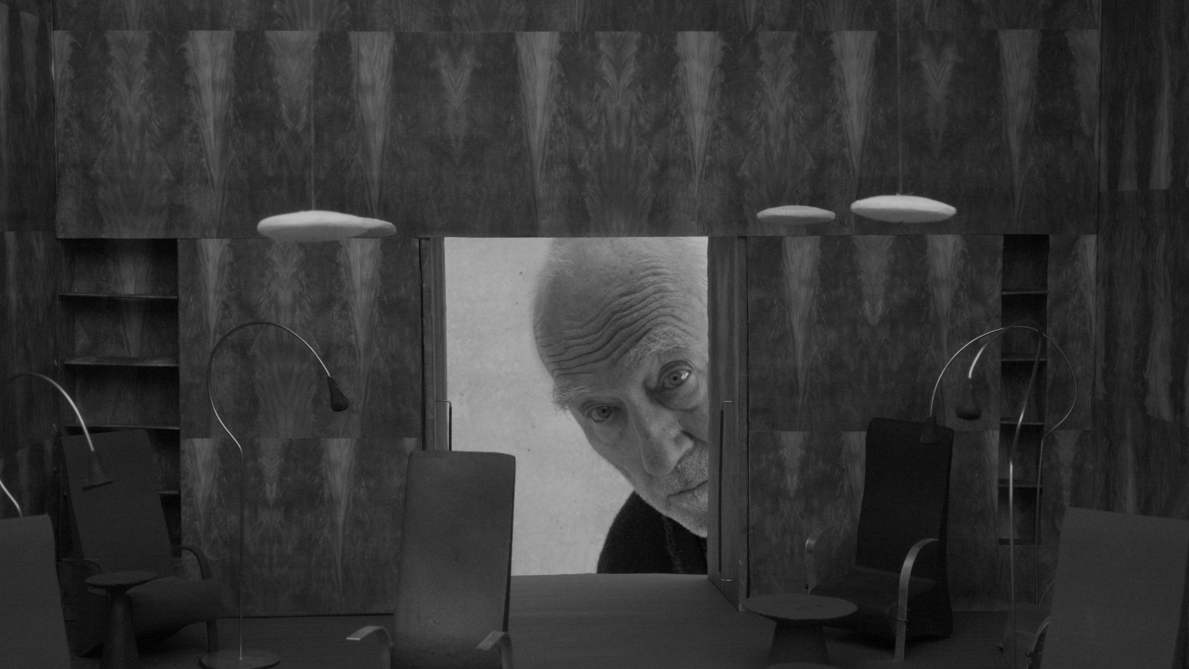 Peter Zumthor peeps into a model of one of his projects in a scene of "From Inside Out".