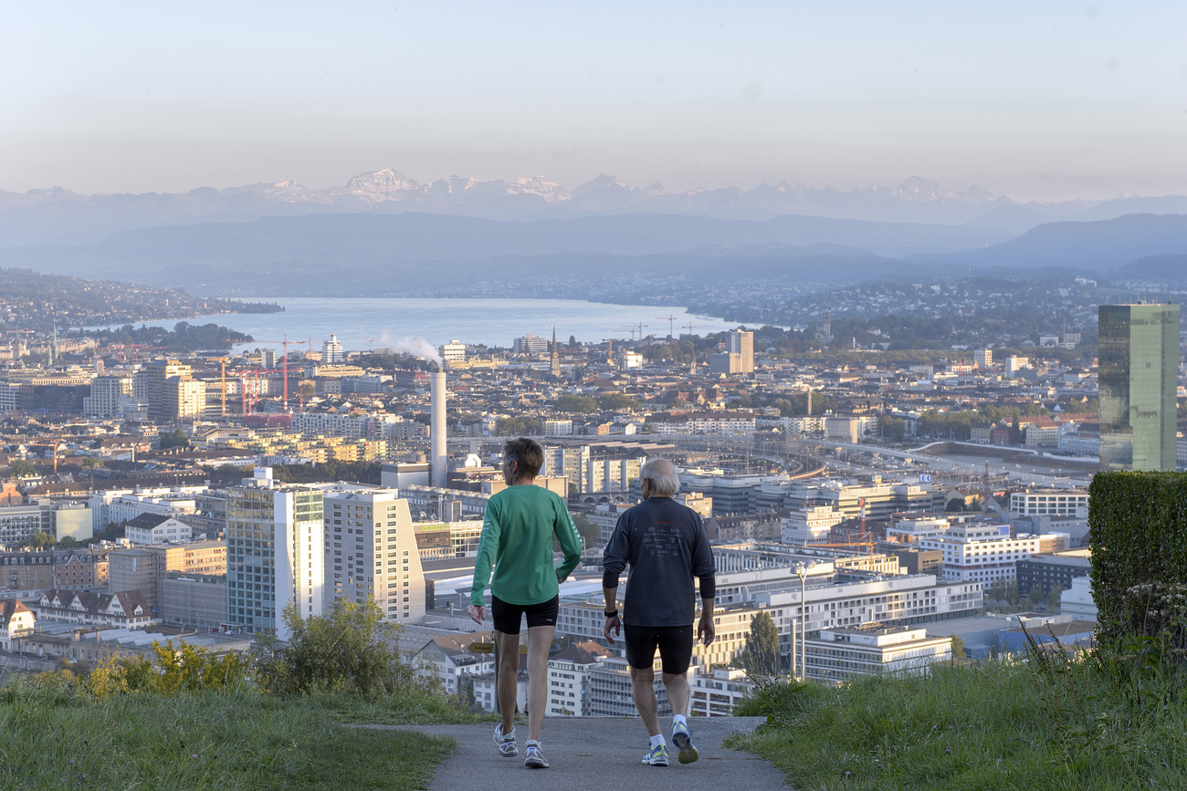 Two men jogging high above Zurich.