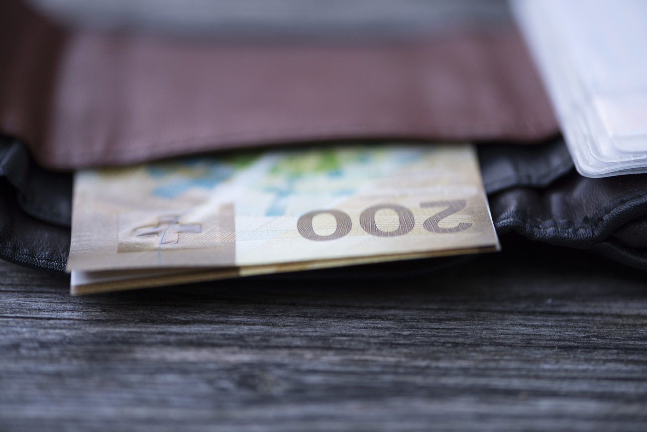 A wallet containing a wad of 200 notes.