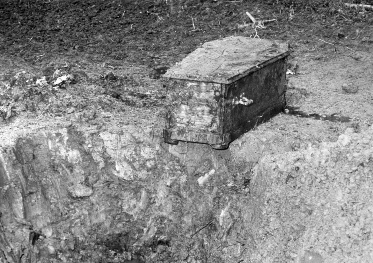 Coffin next to a hole in the ground