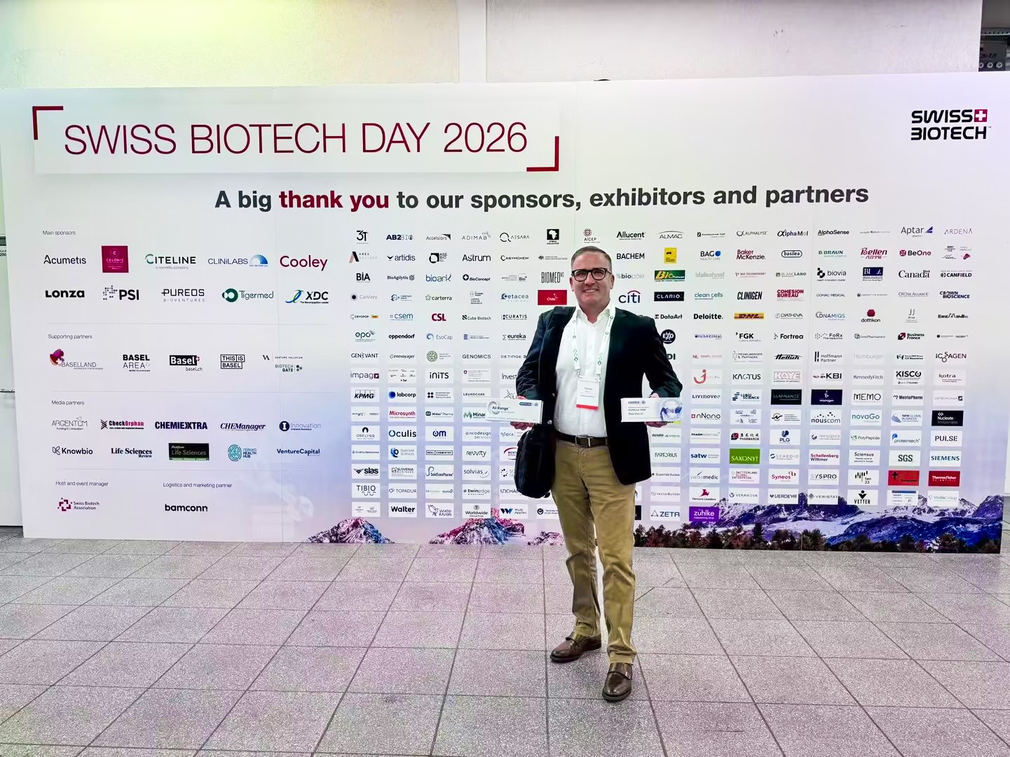Man in front of logos