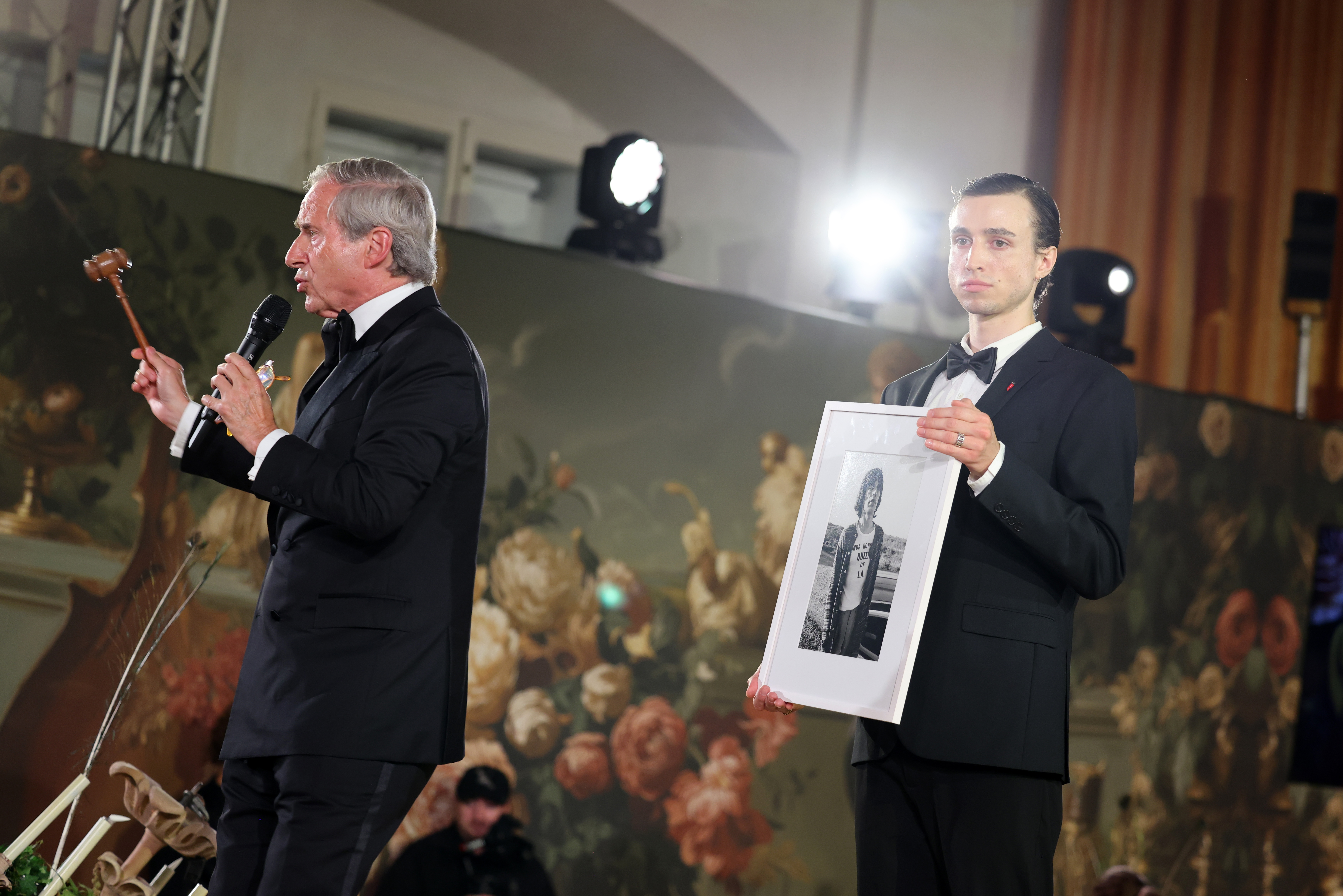 Simon de Pury (left) presents a picture of Mick Jagger in Montauk (1977), an item for auction, onstage during a gala in Salzburg, Austria (August, 2025).