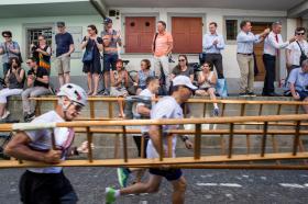 Men running with ladders through a street