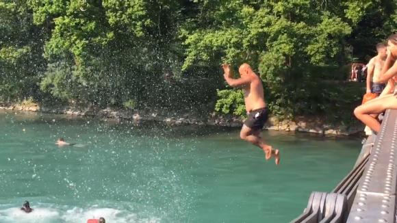 Man jumps from bridge into river