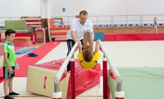 trainer and gymnast practice
