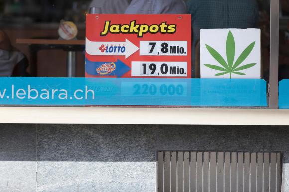 A poster in the shop window advertises the sale of legal cannabis
