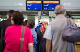 Passengers at Stuttgart airport checking in to go to Turkey