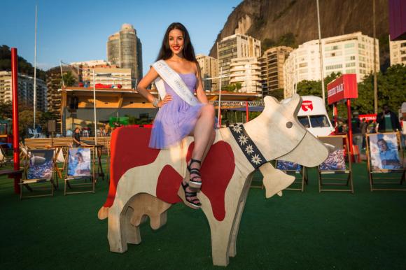 Beauty queen sits atop wooden horse in Rio de Janeiro