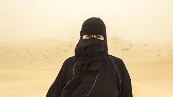 امرأة سعودية متنقبة ترتدي عباءة سوداء