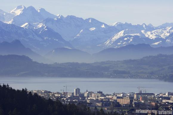 A town next to a lake framed by mountains