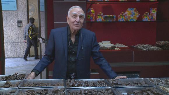 Arnoldi standing in front of chocolates