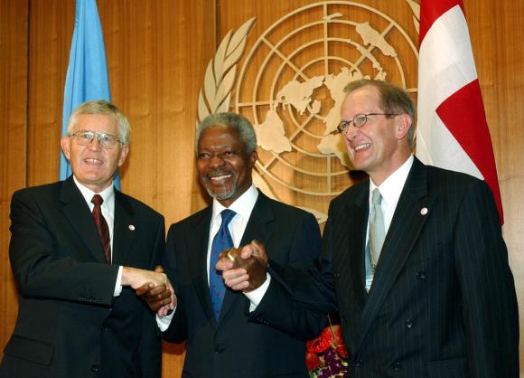 Kofi Annan comemorando com o então presidente suíço Kaspar Villiger e o ministro do Exterior Joseph Deiss.