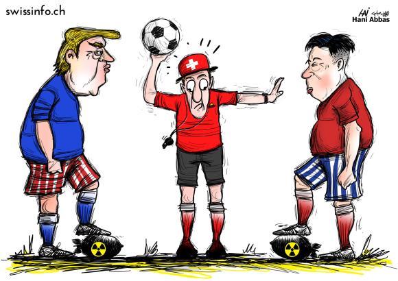 حكم كرة القدم يتوسط ترامب وكيم يونغ وقد وضع كل واحد منهما رجلا فوق قنبلة نووية