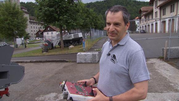 man with mine sweeping device in hands