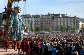 A grandmother giant puppet parades through the spectators during the The Saga of the Giants street theatre