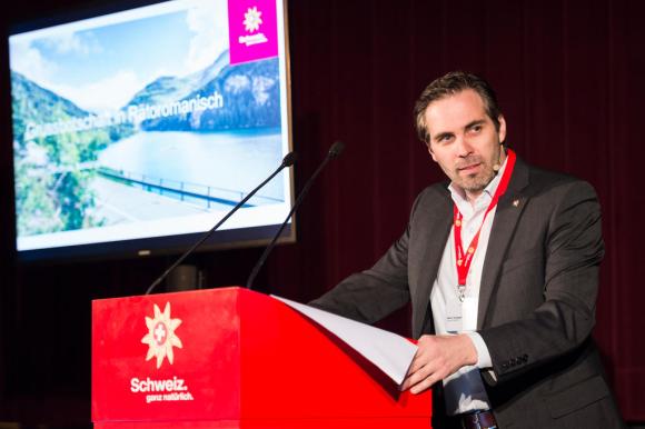 Martin Nydegger, the new head of Switzerland Tourism, at a podium