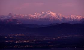 The Mont Blanc is illuminated by the setting sun at dusk in La Barillette.