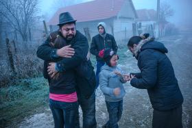Romanian family reunited. Father hugs his daughter.