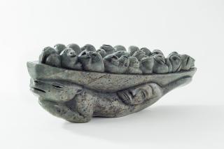 sculpture of beings in a boat