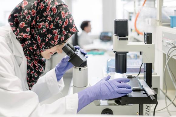 A scientist wearing a headscarf