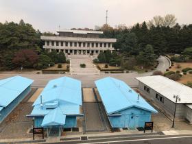 Three blue barracks - known as Conference Row - connect North Korea (visible across the street) and the South.