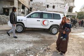 امرأة وطفل وسيارة إسعاف في أحياء مزقتها الحرب بضواحي العاصمة السورية دمشق