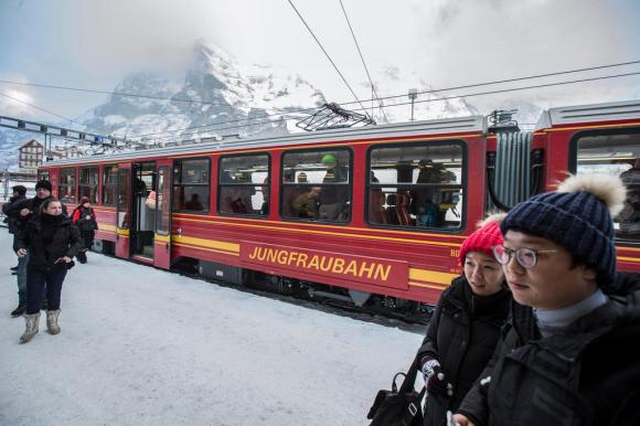 Tourists take selfies on top of the Jungfraujoch