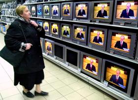 Russian woman looking at TVs