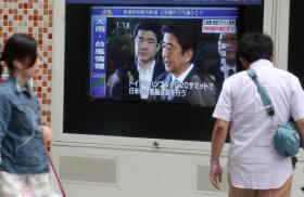Japanese passers-by watching TV