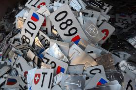 Car number plates are processed for disposal in a workshop in Ticino