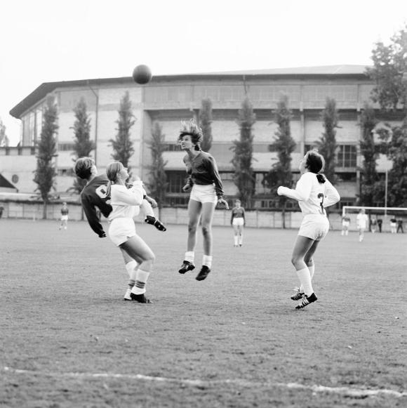 A woman heads the ball