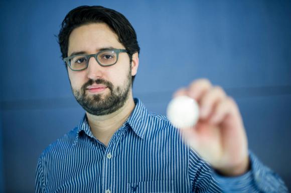 Luzius Meisser holds up a bitcoin