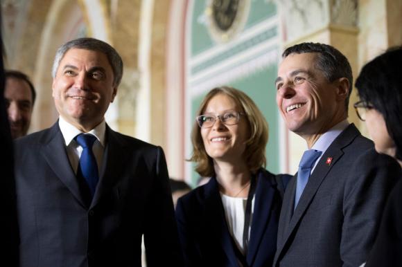 Smiling Swiss and Russian diplomats in Swiss parliament