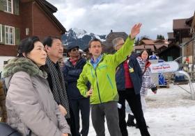 Diplomats looking up to mountains