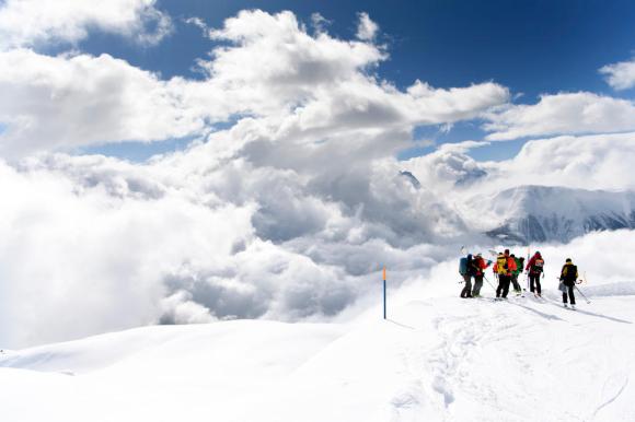 Rescue crews search for five hikers carried away yesterday by an avalanche over the Fiescheralp.
