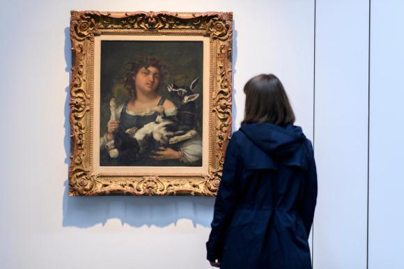A woman looks at a painting