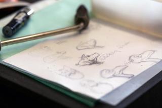 Sketches of animal shapes on paper.