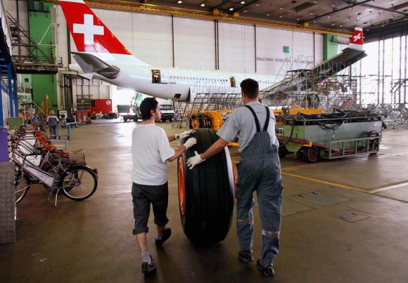 men with plane tire