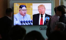 Footage of US President Donald Trump (right) and North Korean leader Kim Jong Un