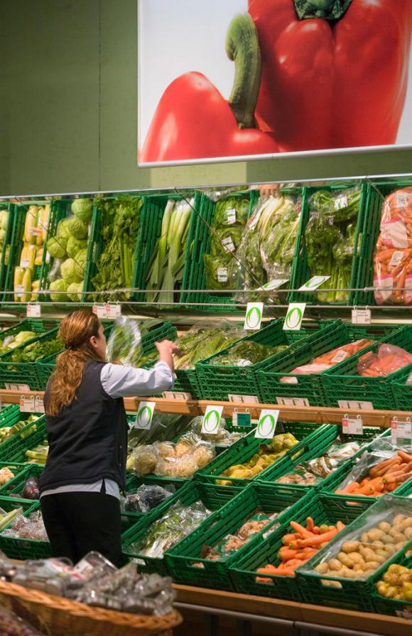 A worker checks the organic fresh food selection at a Coop supermarket in Wetzikon in 2007