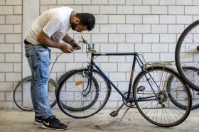 man working with bicycle