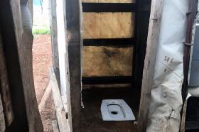 Interior view of a latrine in the ground.